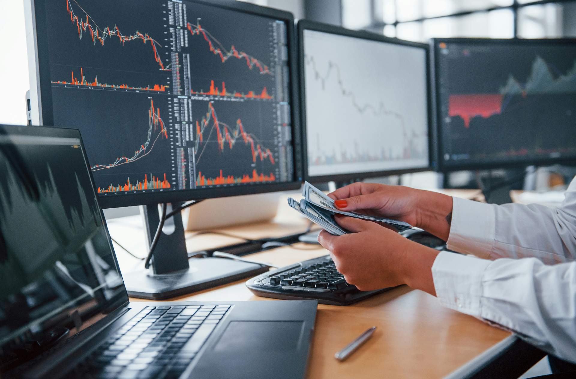 Investors analyzing EB-5 deal documents and financial charts in a professional meeting