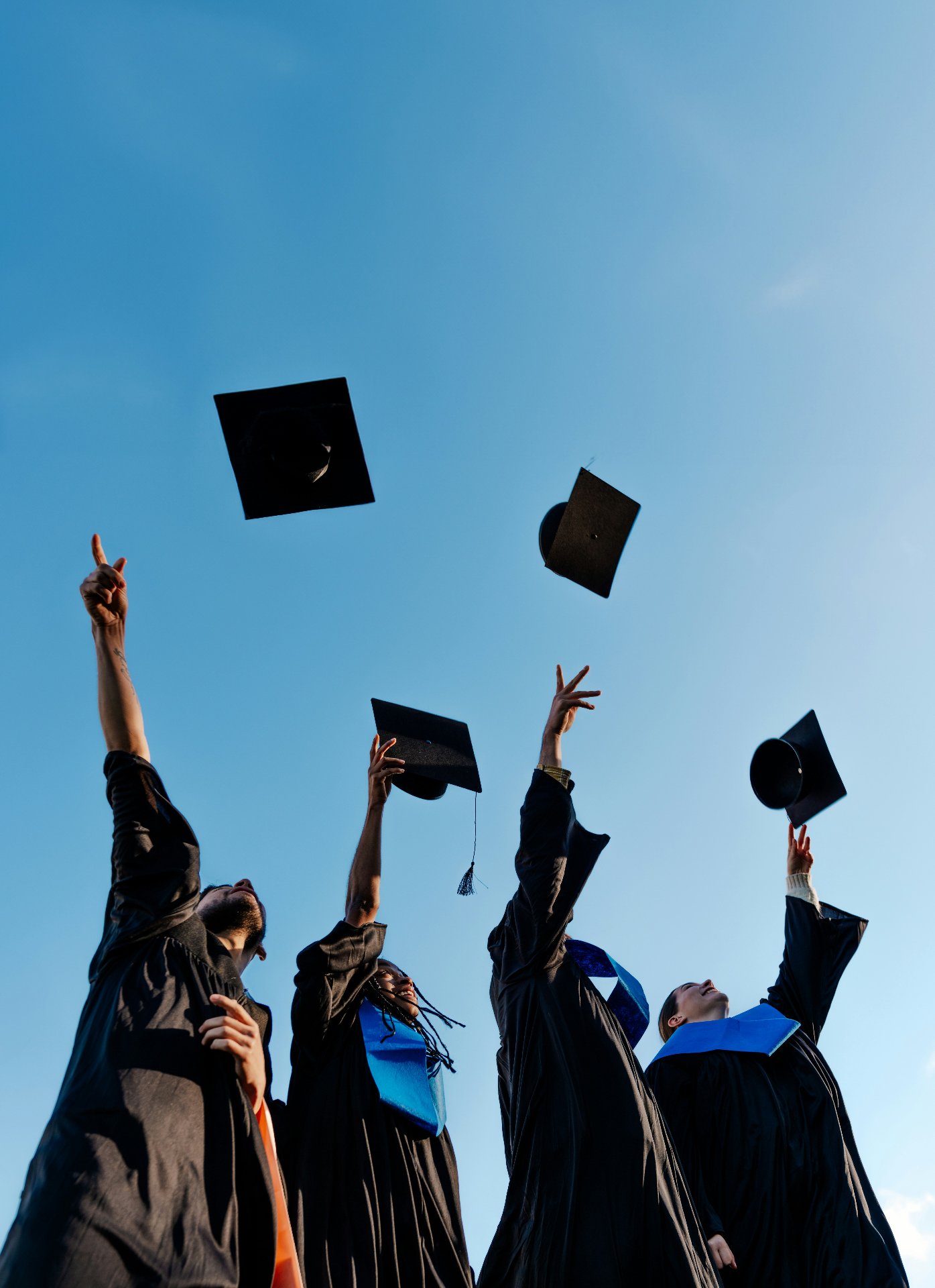 International students celebrating graduation at US university with EB-5 visa benefits