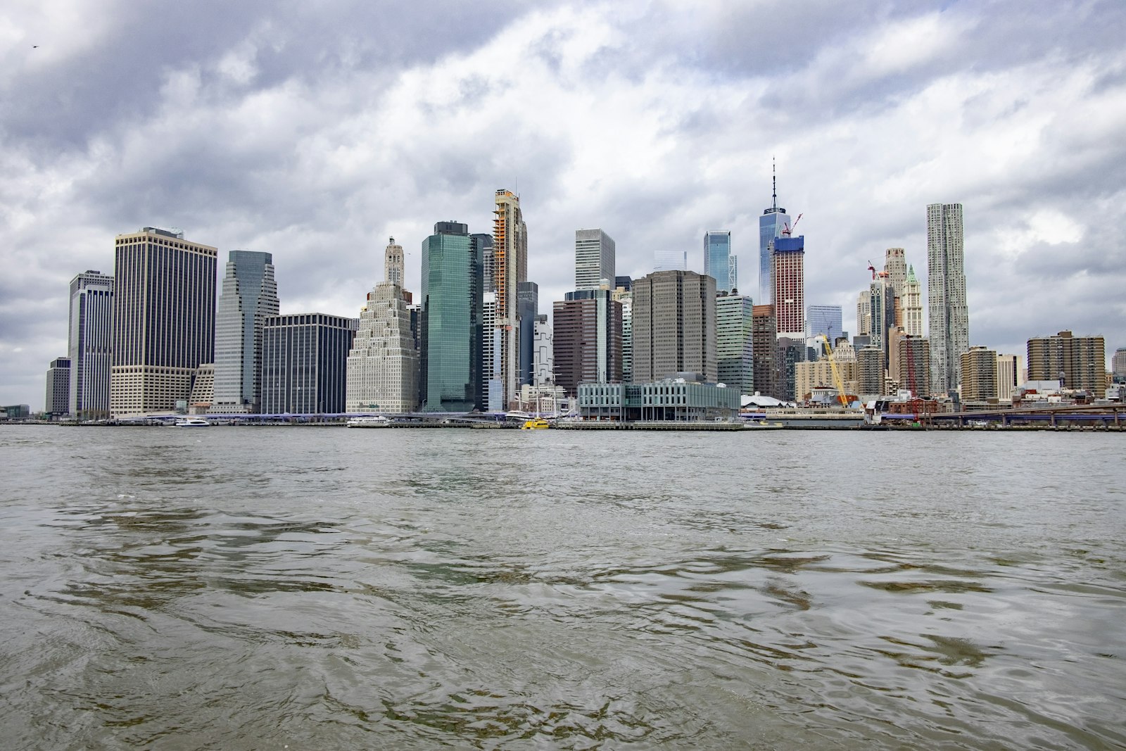 Lower Manhattan financial district skyline under a cloudy sky